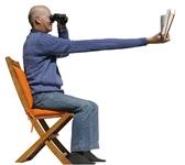 Gentleman_reading_book_through_binoculars!.jpg